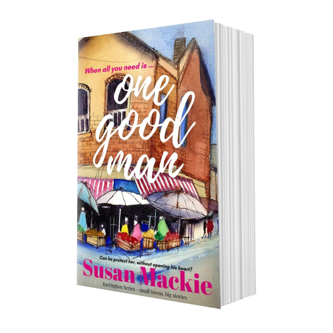 Book titled 'One Good Man' by Susan Mackie with a colorful street scene on the cover.