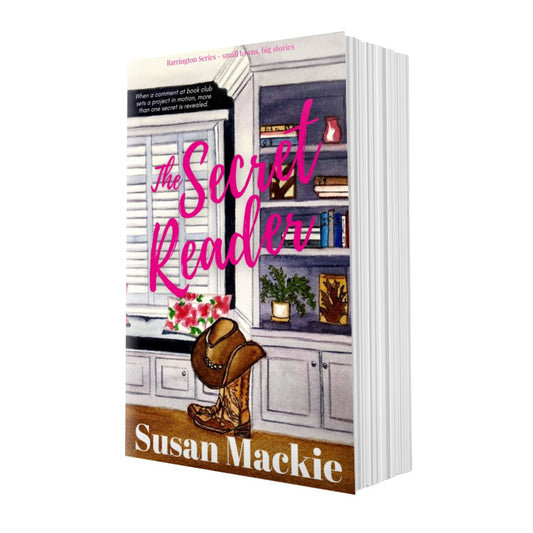 Book cover of 'The Secret Reader' by Susan Mackie with a cozy interior design scene.